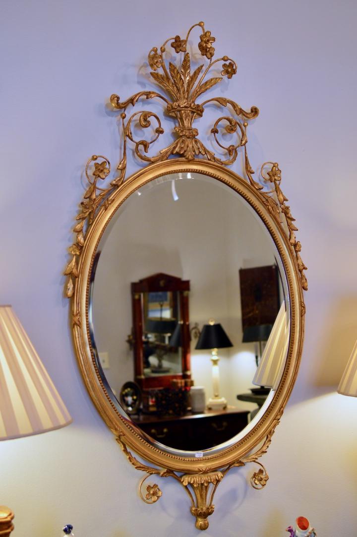 Oval gilt mirror w/ scroll leaf & flowers
