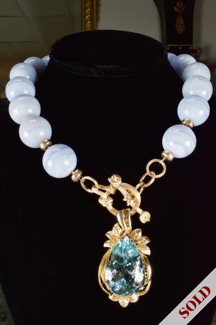 Lace agate bead necklace suspended by aquamarine pendant