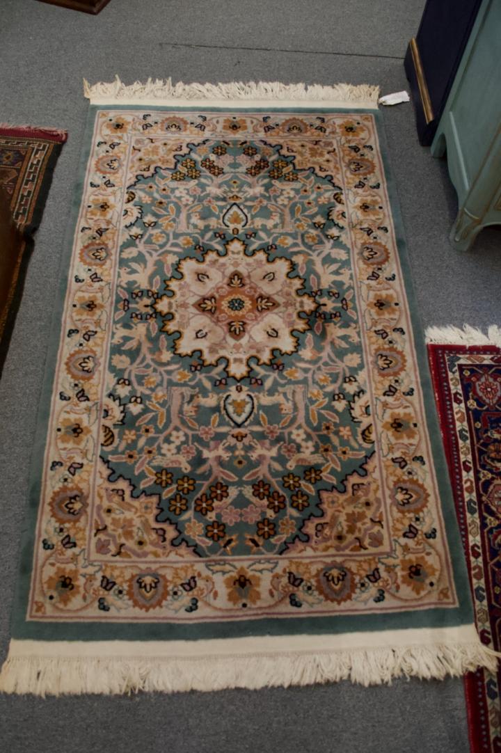 Shop Green, gold, off white animal & foliage knotted wool rug | Hunt & Gather