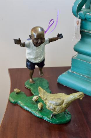 Chinese boy chasing chickens - bronze sculpture