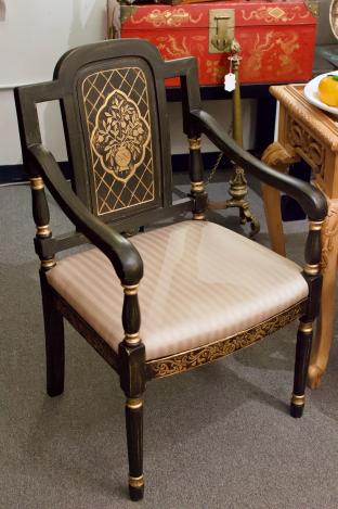 Pair of black and gold armchairs
