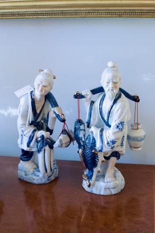 Pair of blue & white asian figurines carrying baskets