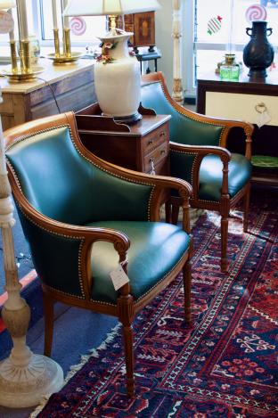 Pair of green leather arm chairs