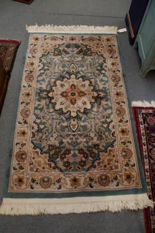 Green, gold, off white animal & foliage knotted wool rug