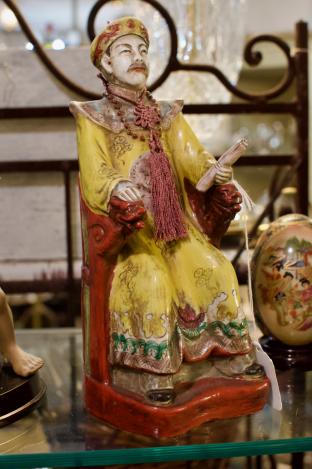 Vintage emperor statue on a dragon throne