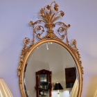 Oval gilt mirror w/ scroll leaf & flowers