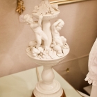 Pair of porcelain Putti & flora urn shaped lamps