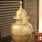 Large vintage hammered brass temple jar on carved wood stand