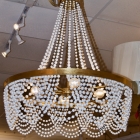 Gold chandelier with white ceramic beads.
