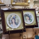Pair of porcelain plates depicting ladies in bonnets