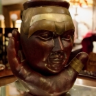 Head on a hand - ceramic & brass