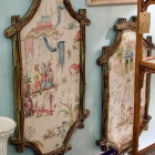 Pair of Asian art pieces in bamboo frame.