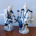 Pair of blue & white asian figurines carrying baskets