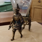 Castilian imports bronze boy pulling cart glass vase
