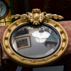 Antique, Empire gilt finished bullseye mirror w/ crest
