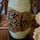 Pair of Asian ceramic pottery vases on stands